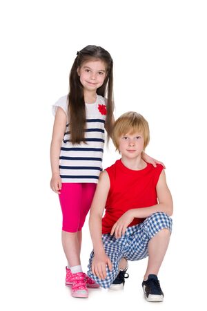 Two smiling children together against the white backgroundの写真素材