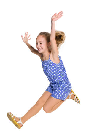 A happy girl jumps on the white backgroundの写真素材