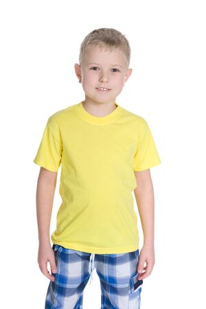 Portrait of a cute little boy in a yellow shirt on the white backgroundの写真素材
