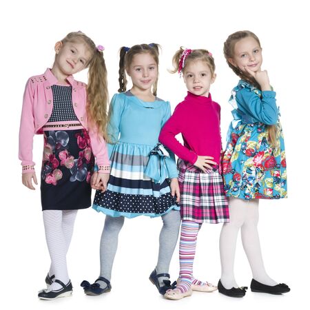 Group of fashion little girls stand against the white backgroundの写真素材