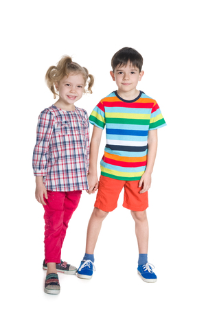 Two fashion children stand together on the white backgroundの写真素材