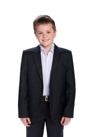 A portrait of a happy schoolboy in the suit on the white backgroundの写真素材
