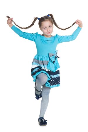 An active little girl with pigtails on the white backgroundの写真素材