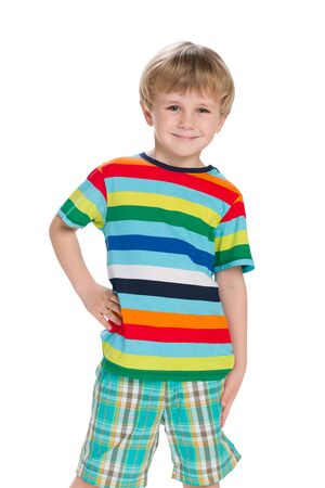 A fashion little boy stands against the white backgroundの写真素材