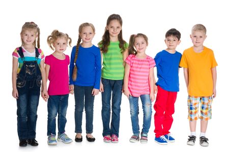 Seven children stand together on the white backgroundの写真素材