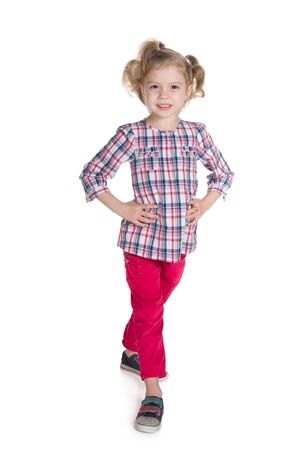 Fashion little girl walks on the white backgroundの写真素材