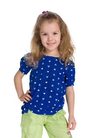 A happy fashion little girl stands against the white backgroundの写真素材