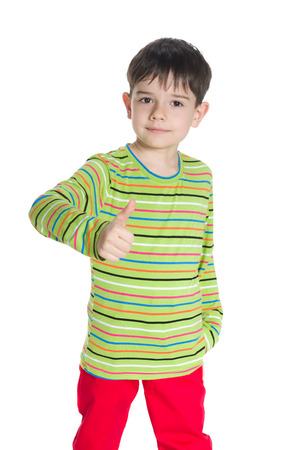 A handsome little boy with his thumb up on the white backgroundの写真素材