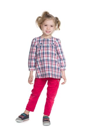 A pretty little girl stands against the white backgroundの写真素材
