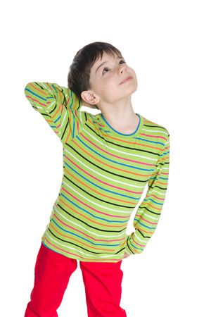A little boy in a striped shirt looks up on the white backgroundの写真素材