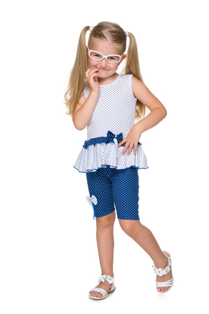 An adorable little girl stands on the white backgroundの写真素材
