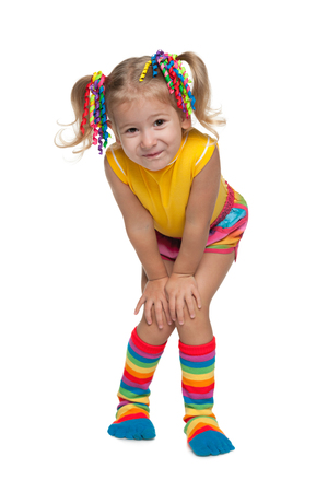 A portrait of a smiling fashion little girl against the white backgroundの写真素材