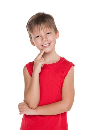 A smiling young boy in a red shirt on the white backgroundの写真素材