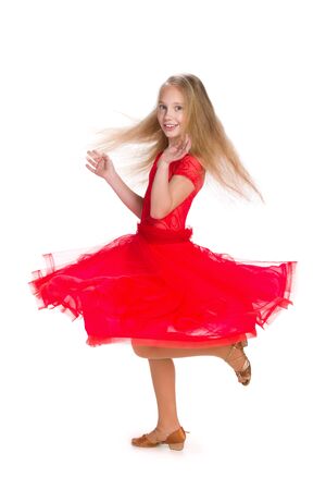 A happy girl in a red dress on the white backgroundの写真素材