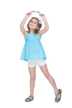 A happy little girl with glasses looks up the white backgroundの写真素材