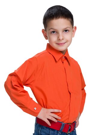 A smiling young boy in a red shirt on the white backgroundの写真素材