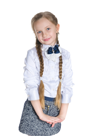 A portrait of a smiling schoolgirl against the white backgroundの写真素材