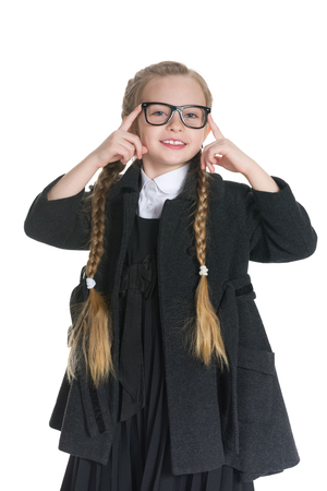 A pretty young girl in glasses against the white backgroundの写真素材