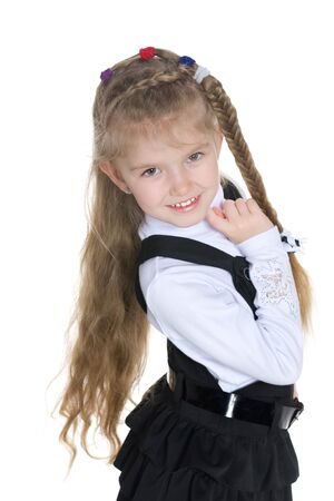 A pretty little girl stands on the white backgroundの写真素材