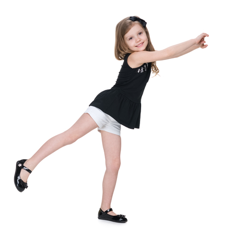 A happy little girl dances on the white backgroundの写真素材