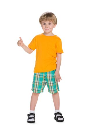 A smiling little blond boy holds his thumb upの写真素材