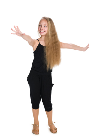 An adorable happy young girl stands on the white backgroundの写真素材