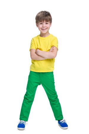A laughing little boy stands on the white backgroundの写真素材