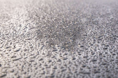 Water drops on metal background with reflection blurred on the edgesの写真素材