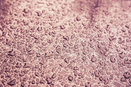 Water drops on metal background with reflection blurred on the edges. Image processing with color filter effectの写真素材