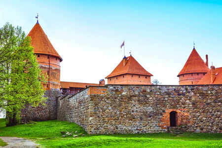 Red brick towers and stone wall of castle in Trakai, Lithuaniaのeditorial素材
