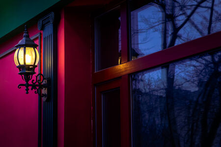 Vintage street lamp at the evening with reflection in windowの写真素材