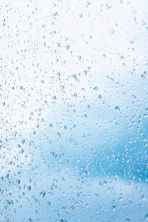 Water drops on window glass, blurred on the edgesの写真素材