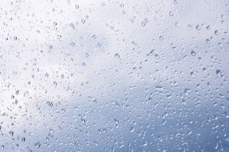 Water drops on window glass, blurred on the edges. Image processing with color filter effectsの写真素材