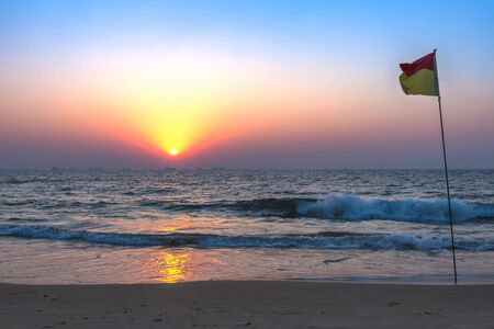Scenic view from sand beach in Goa to beautiful sunset above the Arabian seaの写真素材