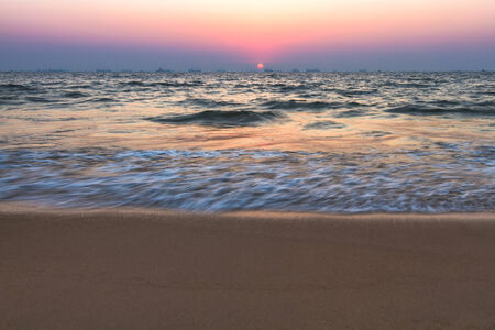 Scenic view from sand beach in Goa to beautiful sunset above the Arabian seaの写真素材
