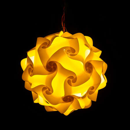 Yellow street lamp on black backgroundの写真素材