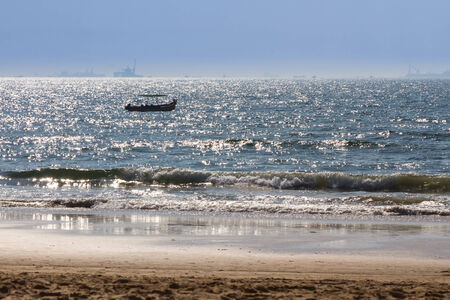 Boats at Arabian sea. Cargo ships on the background. View from beach in Goa, Indiaの写真素材