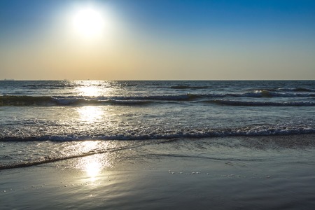 Scenic view from beach in Goa to beautiful sunrise above the Arabian sea. Sun reflection on sea surfaceの写真素材