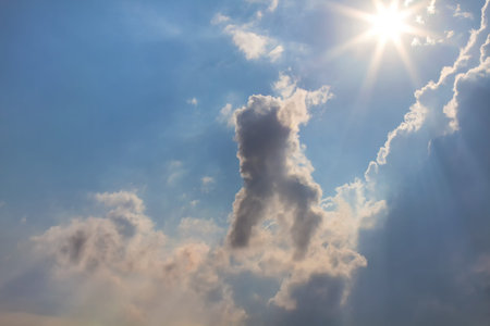 Sun and clouds on sky backgroundの写真素材