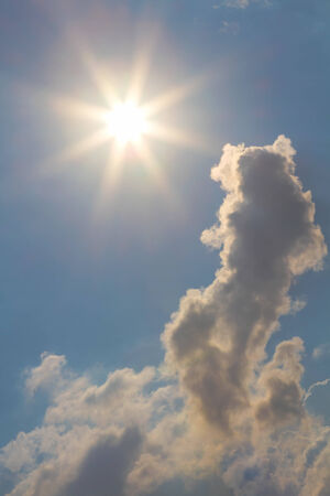 Sun and clouds on sky backgroundの写真素材