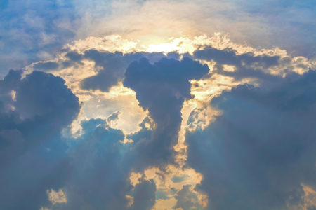 Sun under clouds on blue sky backgroundの写真素材