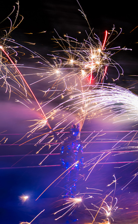 Fire performer in motion at nightの写真素材