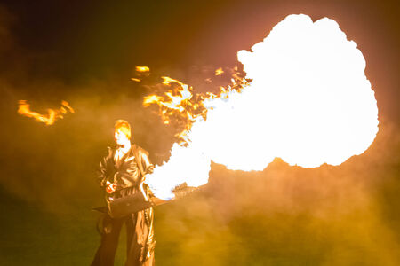 Minsk, Belarus - MAY 25, 2013  annual festival fire show  MIFF   Performance of artists on stage  Man with flamethrowerのeditorial素材
