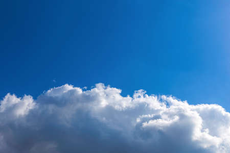 White fluffy clouds on blue sky backgroundの写真素材