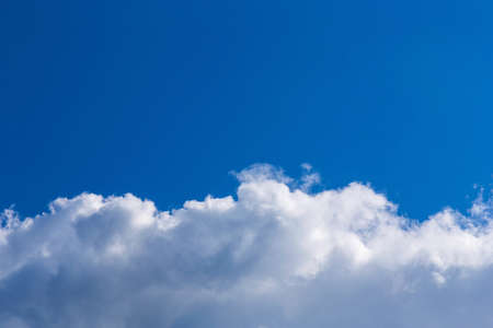 White fluffy clouds on blue sky backgroundの写真素材