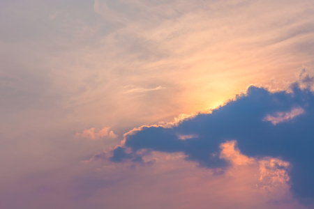 Sun under clouds on blue sky backgroundの写真素材