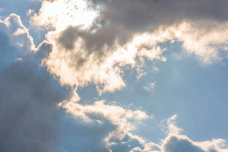 Sun under clouds on sky backgroundの写真素材