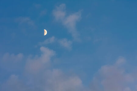 Moon or crescent on blue sky background with pink cloudsの写真素材