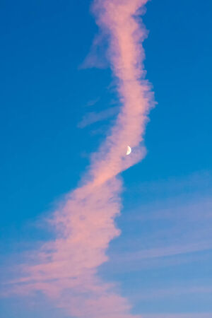 Moon or crescent on blue sky background with pink cloudsの写真素材