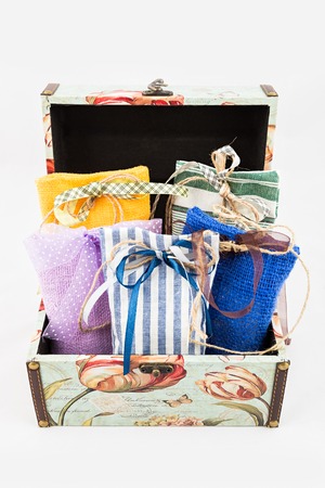 Decorative textile sachet pouches in gift box on white backgroundの写真素材
